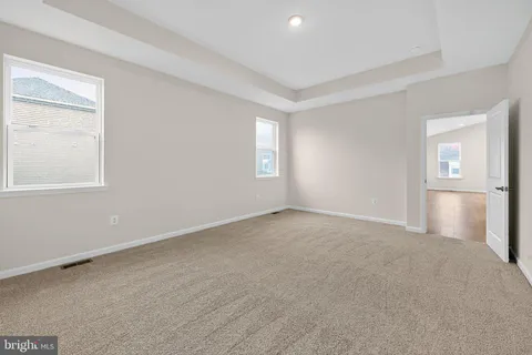 an empty room with windows and closet