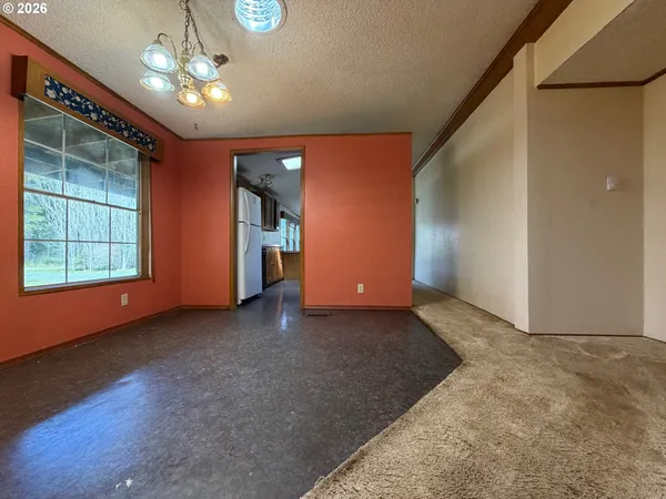 a view of a livingroom with a ceiling fan and window