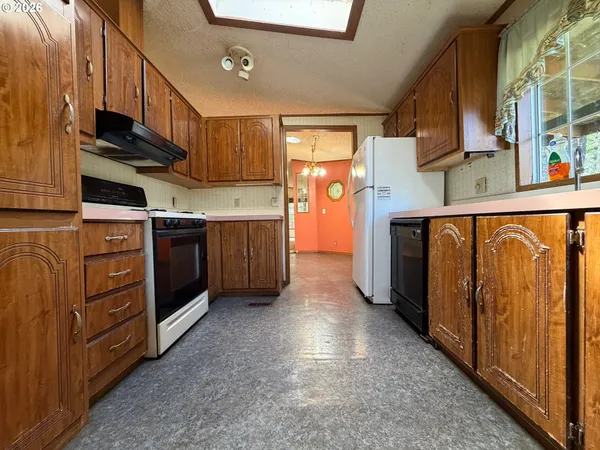 a kitchen with wooden cabinets and a stove top oven