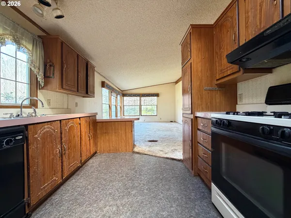 a view of a kitchen with a sink washer and dryer