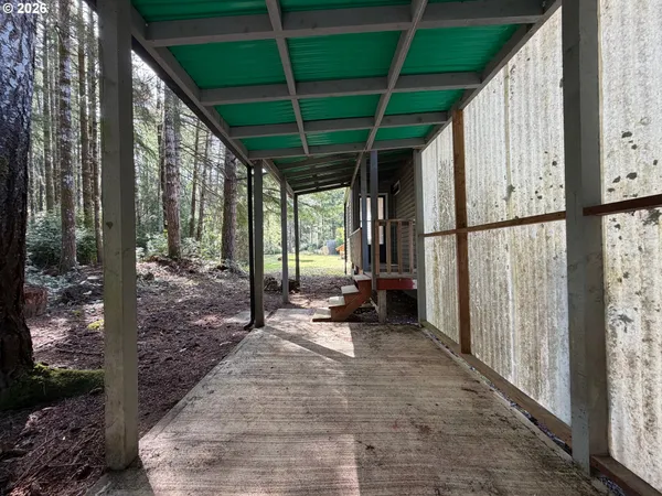 a view of a deck with a table and chair under an umbrella