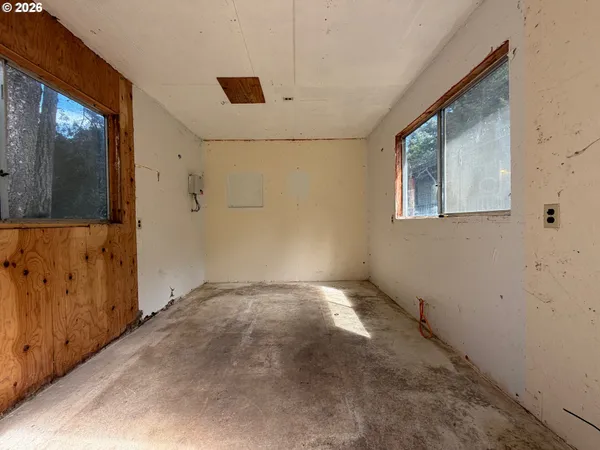 a view of empty room with wooden ceiling
