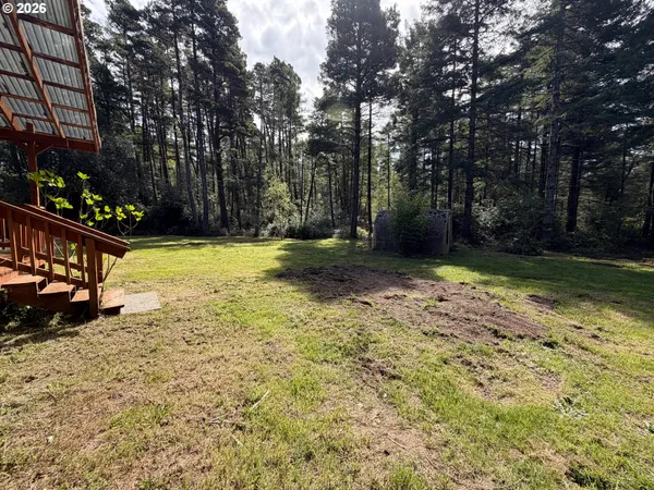 a view of a wooden deck with a yard