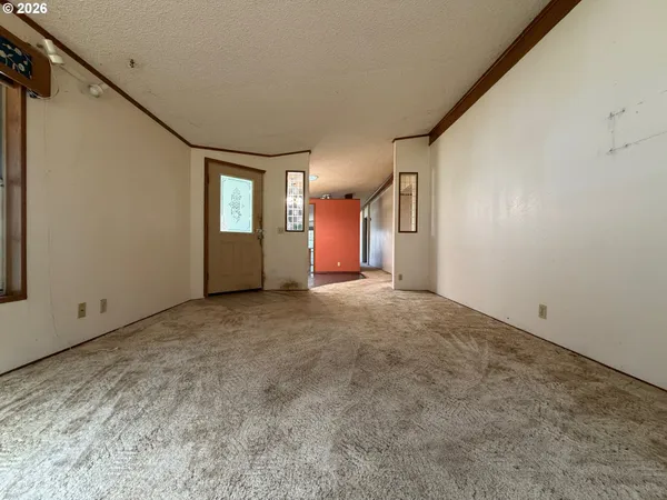 a view of a livingroom with a ceiling fan and window