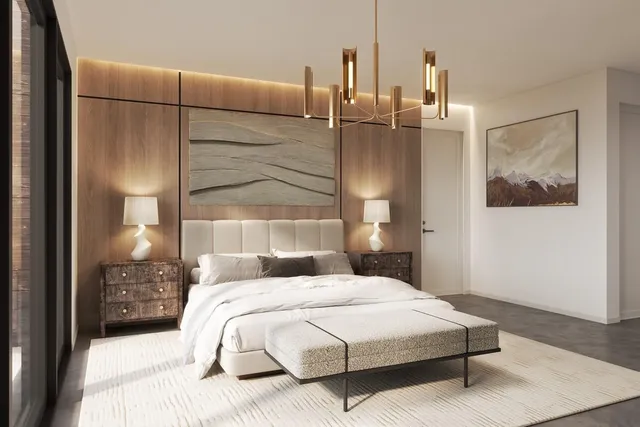 a bedroom with a bed a mirror and lamp