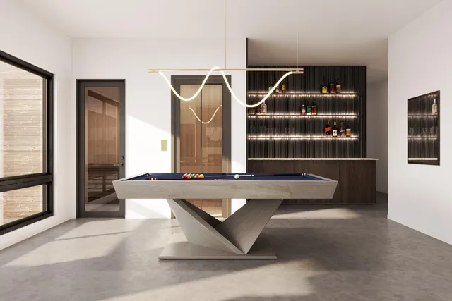 a living room with table chairs and a potted plant