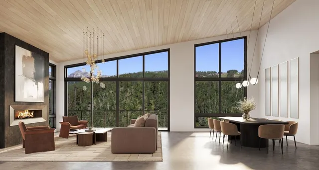 a dining room with furniture and large windows