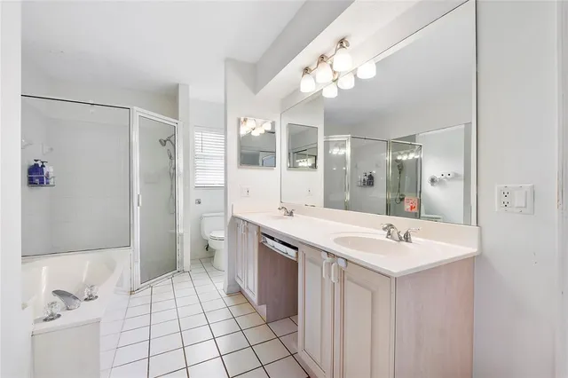 a spacious bathroom with a shower a sink and a mirror