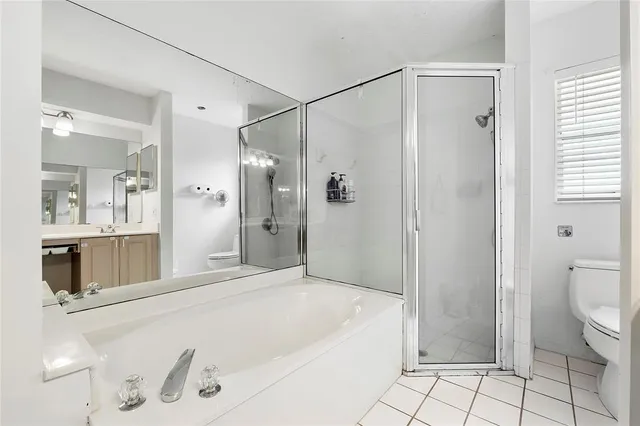 a bathroom with a tub a sink and a mirror