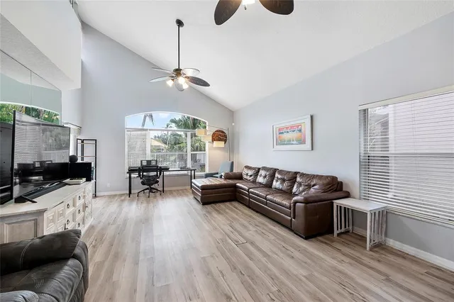 a living room with furniture flat screen tv and wooden floor