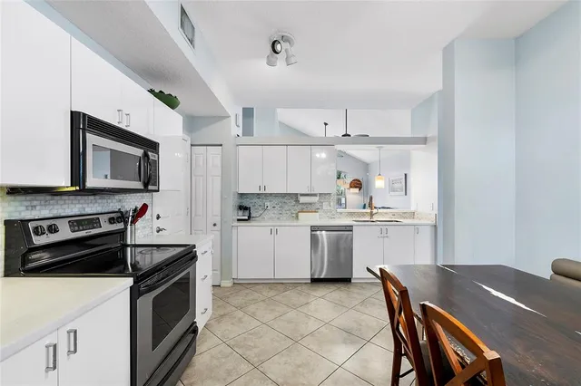 a kitchen with a stove microwave and cabinets