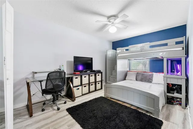 a bedroom with furniture and a flat screen tv