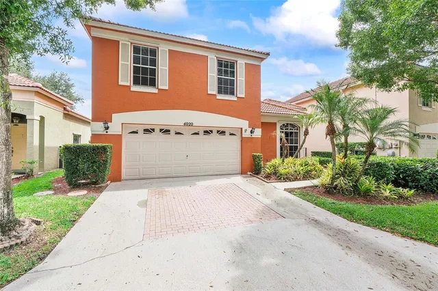 a front view of a house with a yard and a garage
