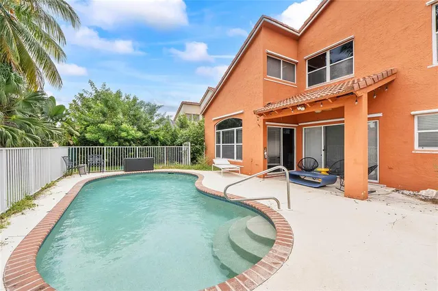 a view of a house with backyard sitting area and roof
