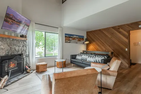 a living room with furniture a window and a fireplace