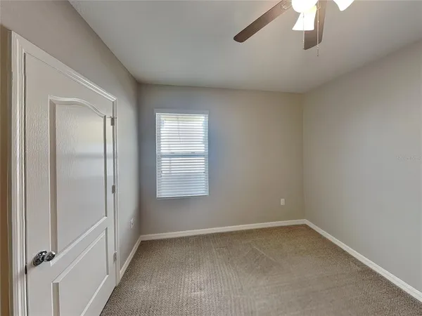 an empty room with a empty space and windows