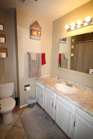 a bathroom with a toilet and a shower curtain