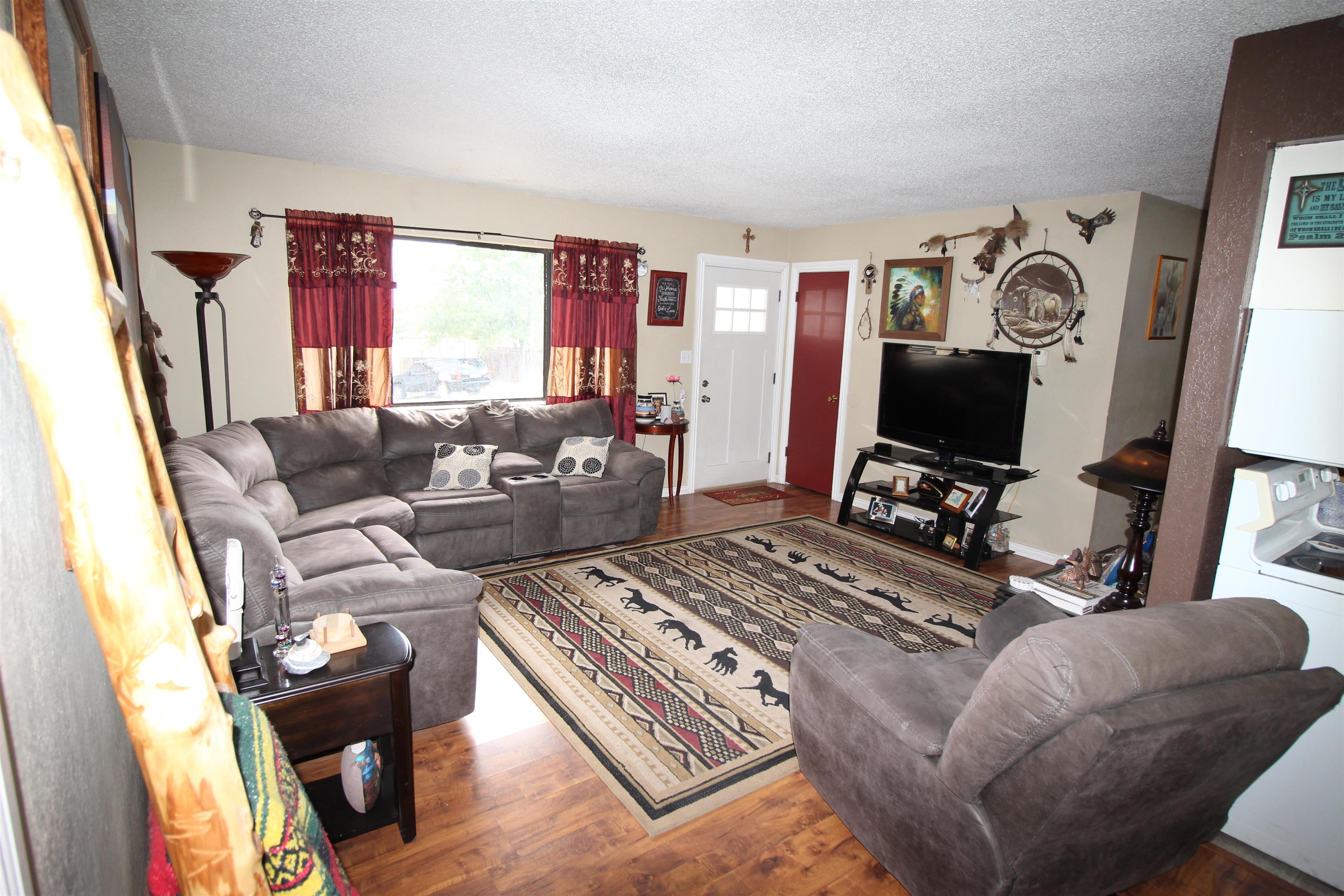 644 Highview Road Clifton, CO 81520 - Photo 4 of 14 a living room with furniture and a flat screen tv