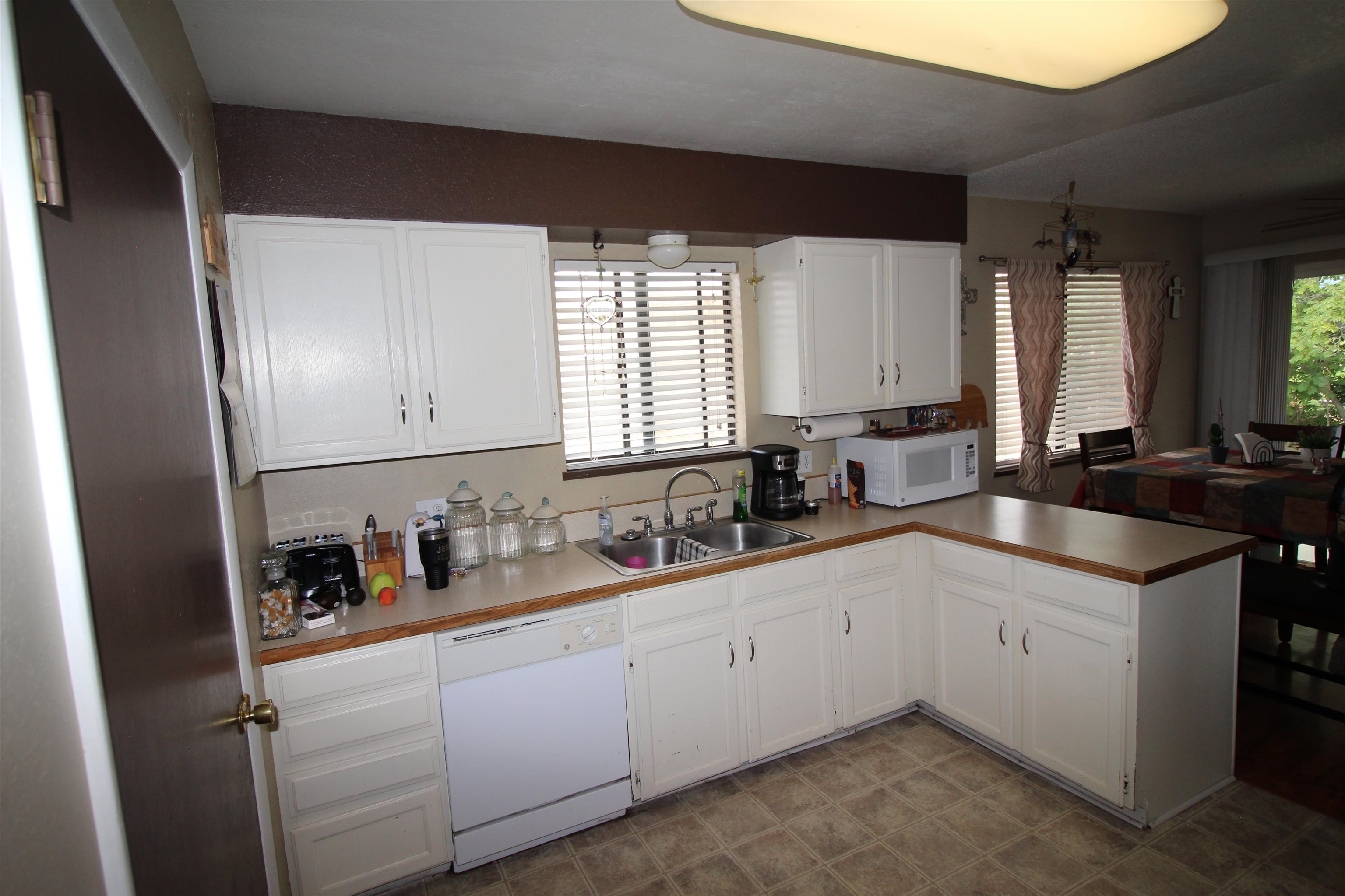 644 Highview Road Clifton, CO 81520 - Photo 5 of 14 a kitchen with a sink dishwasher and white cabinets