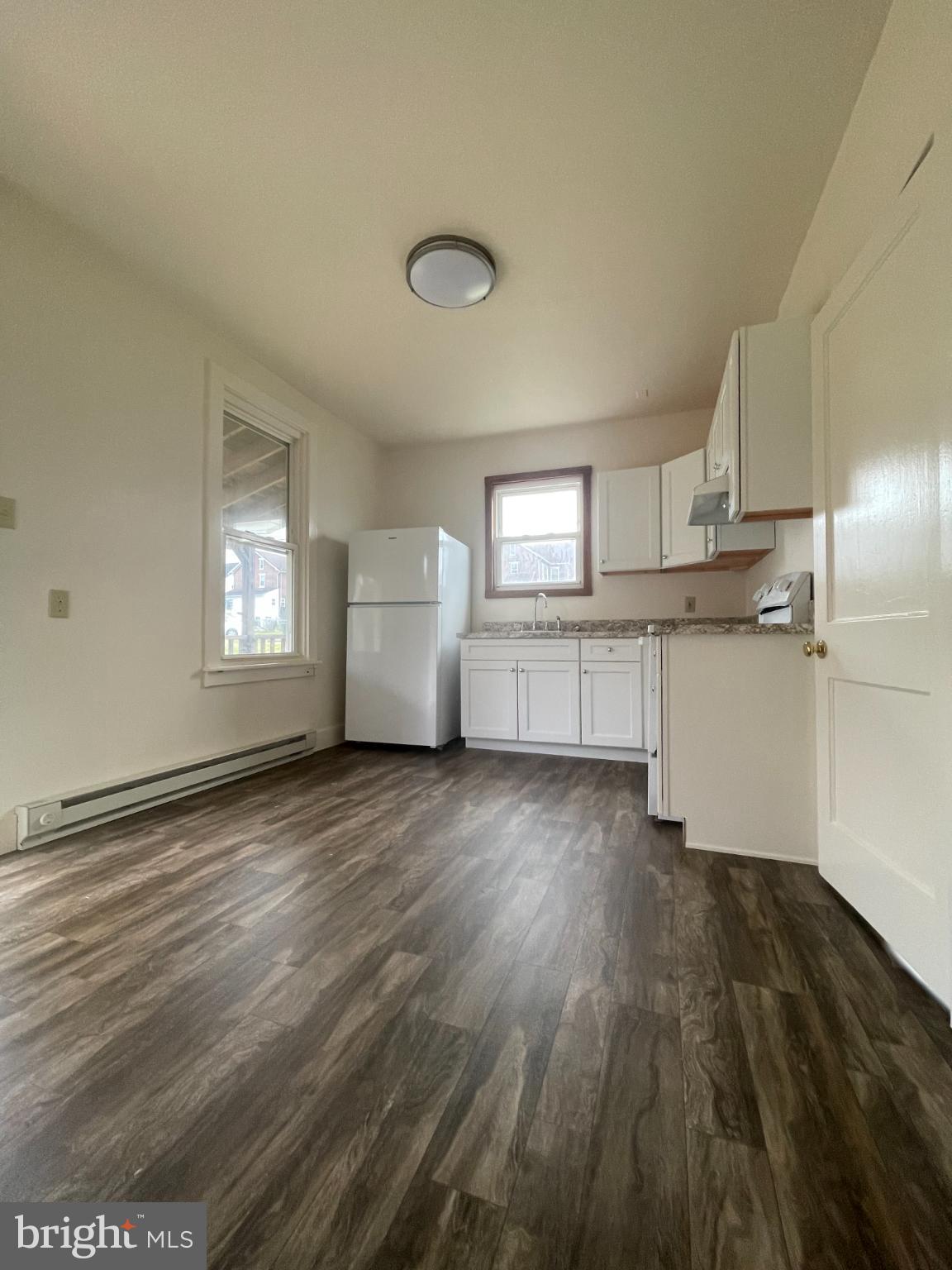 452 West 1st Street, Unit 3 Birdsboro, PA 19508 - Photo 3 of 12 a kitchen with stainless steel appliances a refrigerator and wooden floor