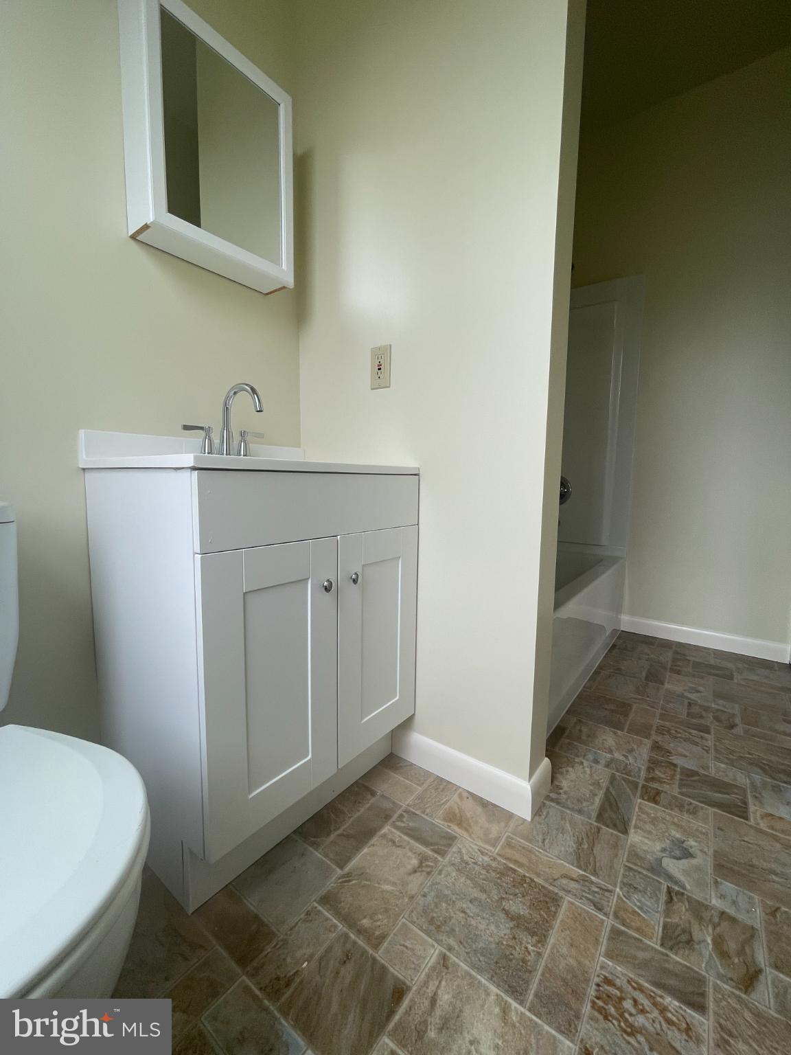 452 West 1st Street, Unit 3 Birdsboro, PA 19508 - Photo 6 of 12 a bathroom with a sink a toilet and mirror