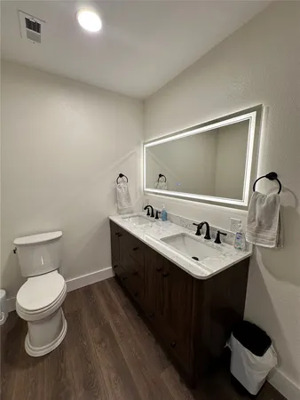 a bathroom with a toilet sink and mirror