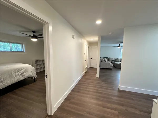 a bedroom with wooden floor and a bed