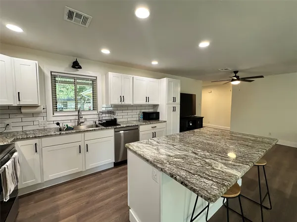 a stove top oven sitting inside of a kitchen