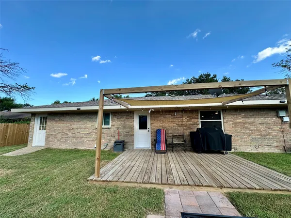 a kitchen with stainless steel appliances granite countertop a stove oven a dining table and chairs with wooden floor