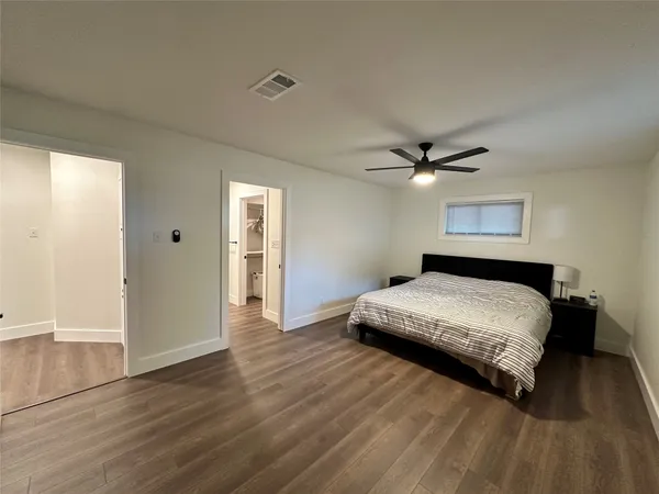 a bedroom with a bed and a ceiling fan