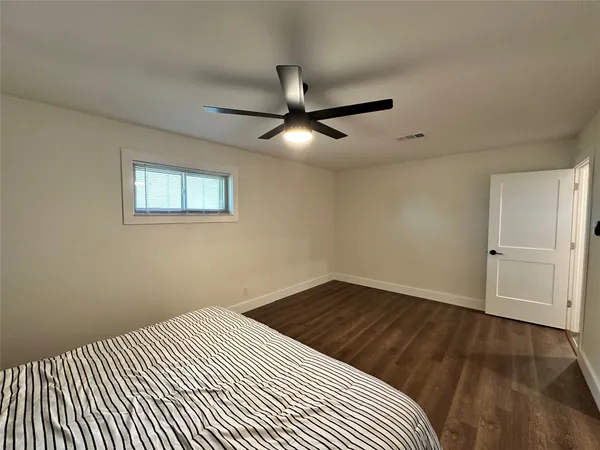 a view of a room with wooden floor and chandelier fan