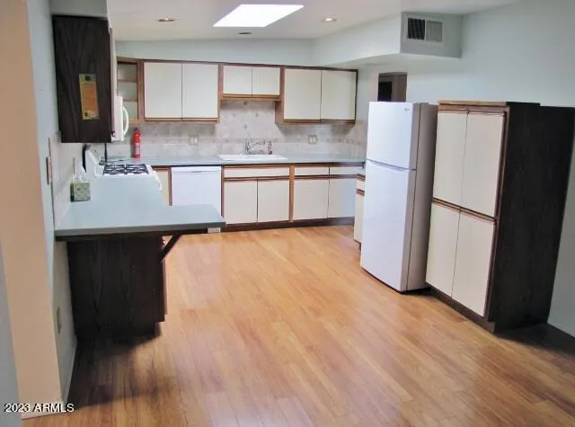 a kitchen with stainless steel appliances a refrigerator sink and microwave