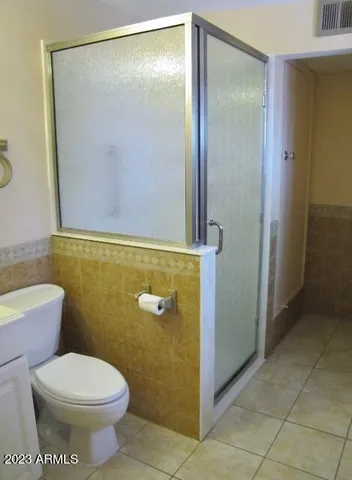 a bathroom with a toilet and a shower