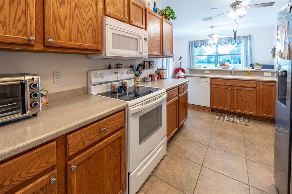 15969 Southwest 14th Avenue Road Ocala, FL 34473 - Photo 11 of 46 a kitchen with a sink stove top oven and cabinets