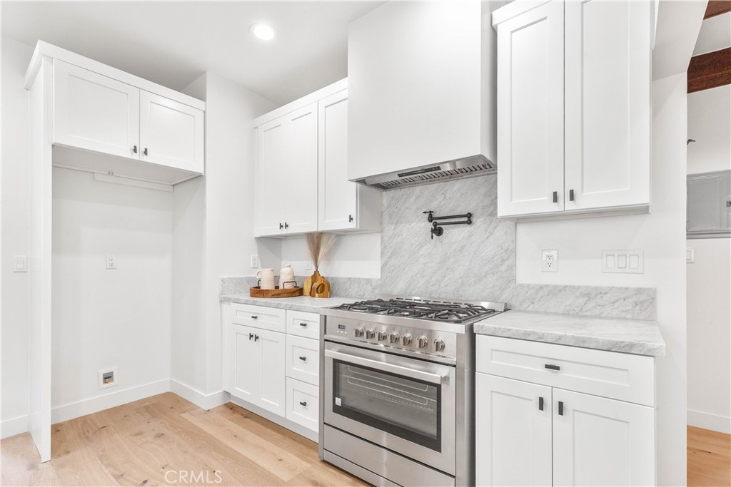 109 Painter Street Pasadena, CA 91103 - Photo 19 of 30 a kitchen with granite countertop white cabinets and white appliances