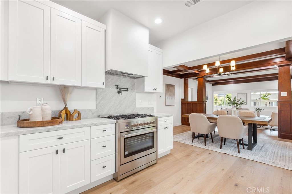 109 Painter Street Pasadena, CA 91103 - Photo 20 of 30 a kitchen with white cabinets and white appliances