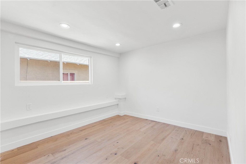 109 Painter Street Pasadena, CA 91103 - Photo 22 of 30 an empty room with wooden floor and windows