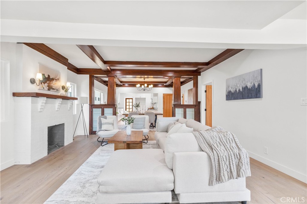 109 Painter Street Pasadena, CA 91103 - Photo 8 of 30 a living room with furniture a fireplace and a floor to ceiling window