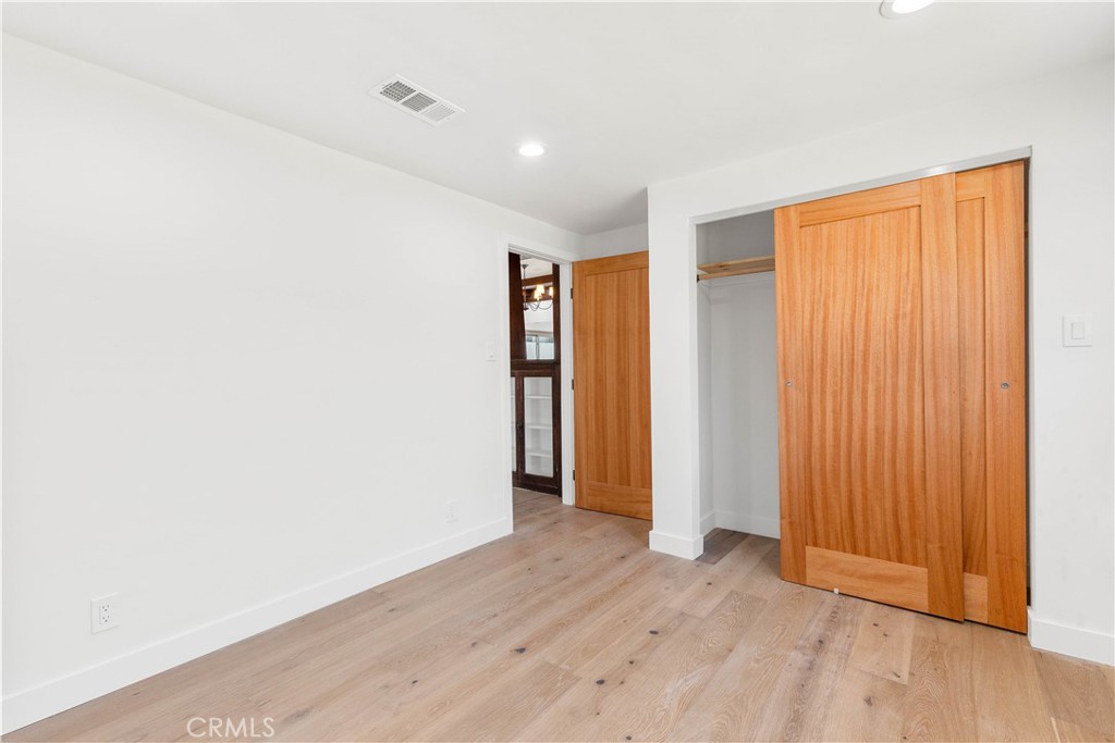 109 Painter Street Pasadena, CA 91103 - Photo 10 of 30 an empty room with wooden floor and closet