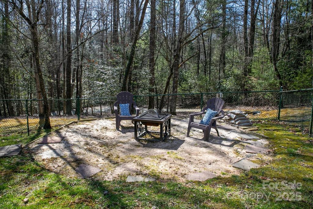 1881 Becky Mountain Road Brevard, NC 28712 - Photo 34 of 40 a bench sitting in the middle of a yard