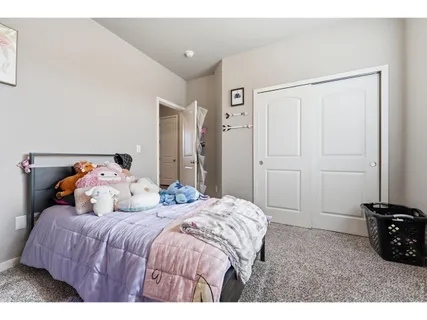 a bathroom with a sink a toilet a mirror and shower curtain