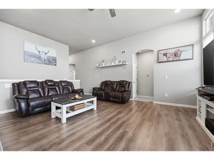 a living room with lots of furniture and kitchen view