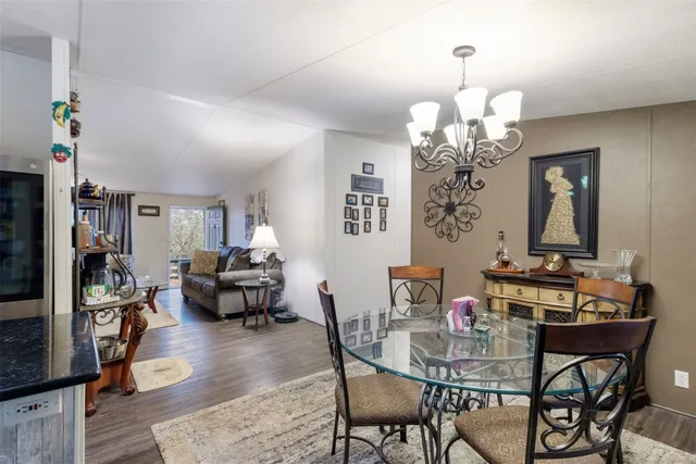 a view of a dining room with furniture wooden floor and a chandelier