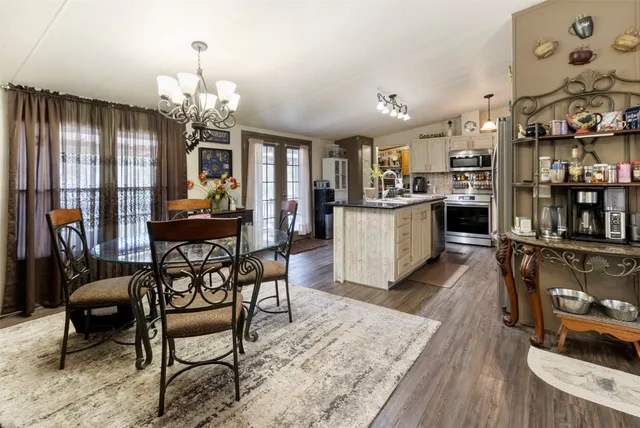 a living room with fireplace furniture and a chandelier