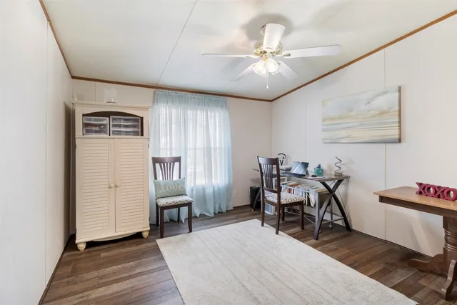 a view of a room with furniture and wooden floor