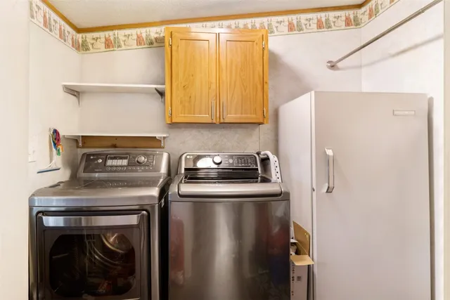 a kitchen with a stove a refrigerator and a sink