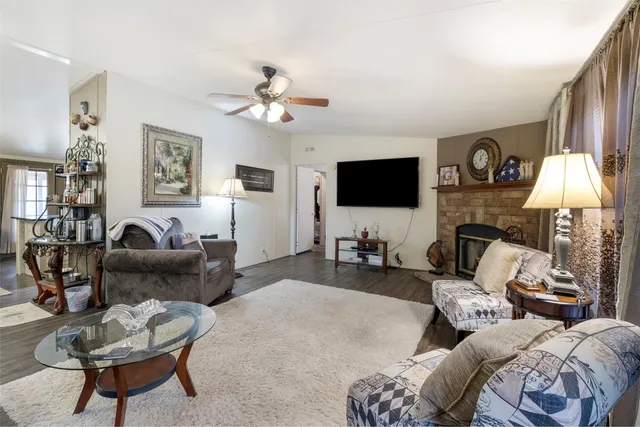 a living room with furniture a fireplace and a flat screen tv