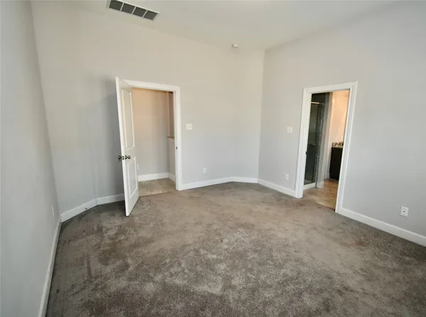 an empty room with closet area