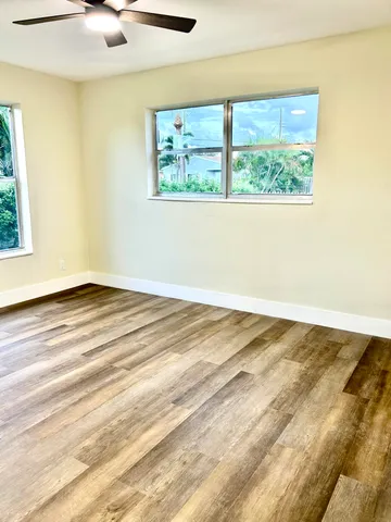 a view of a room with wooden floor and window