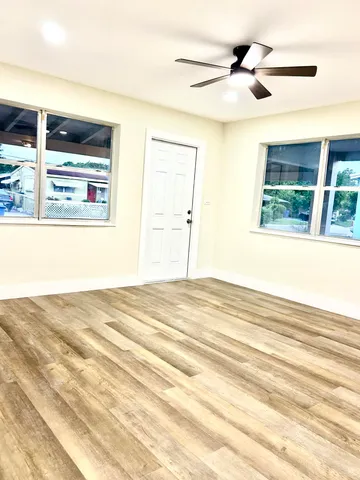 a view of a livingroom with a ceiling fan and window